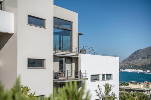 a white building with a view of the water at Seametry Luxury Living Penthouse in Souda