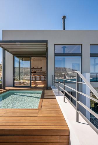 a house with a swimming pool and a deck at Seametry Luxury Living Penthouse in Souda