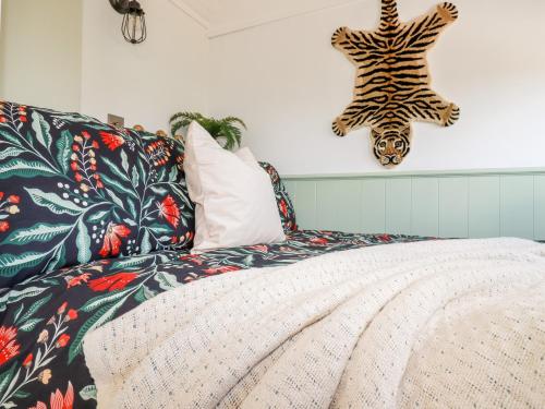 a bedroom with a zebra headboard and a bed at Badgers Rest in Tintagel