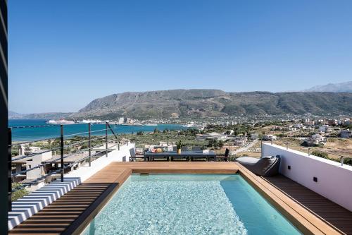 a balcony with a pool and a view of the ocean at Seametry Luxury Living Penthouse in Souda