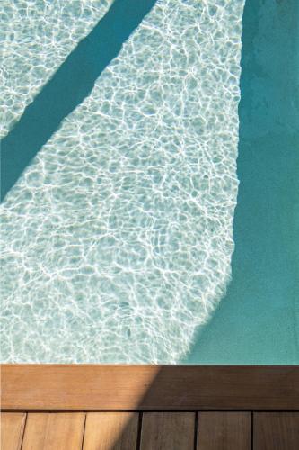 a pool of water with a reflection of the ocean at Seametry Luxury Living Penthouse in Souda
