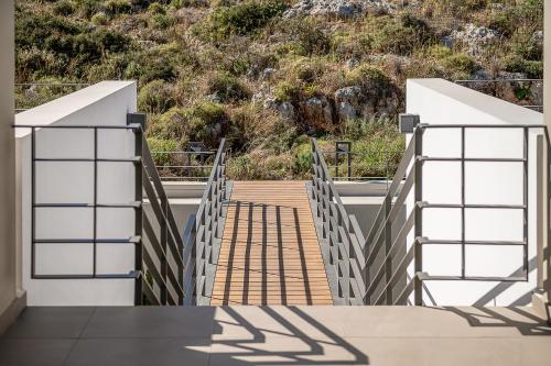 a stairway leading up to a building with a hill at Seametry Luxury Living Penthouse in Souda