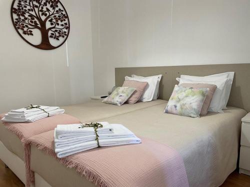 a bedroom with two beds with towels on them at My Portugal for All - Oporto Flat in Vila Nova de Gaia