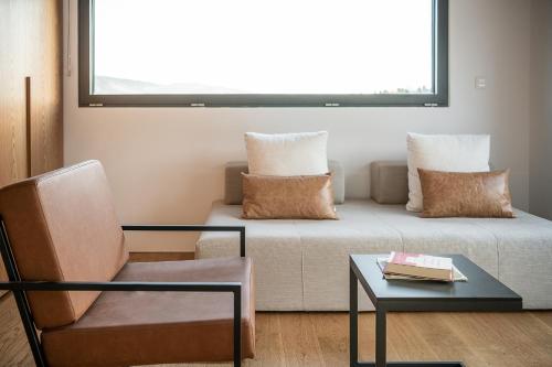 a living room with a couch and a chair at Seametry Luxury Living Penthouse in Souda