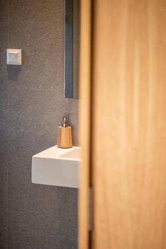 a bathroom with a white sink and a mirror at Seametry Luxury Living Penthouse in Souda