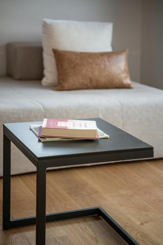 a black coffee table with a book on top of it at Seametry Luxury Living Penthouse in Souda