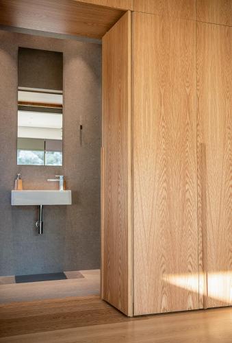 a wooden door in a room with a sink at Seametry Luxury Living Penthouse in Souda