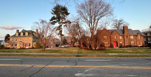 an empty street in front of a large brick house at The Manor on Front in Harrisburg