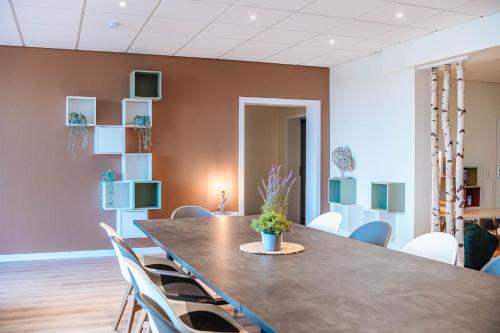 a dining room with a large table and chairs at XXL Ferienhaus Goldberger See - Sauna - 16 Personen in Goldberg