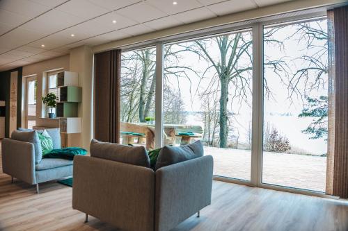 a living room with a large glass window at XXL Ferienhaus Goldberger See - Sauna - 16 Personen in Goldberg