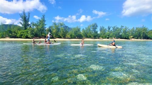 a group of people on kayaks in the water at sweet island studio ocean in Rivière Noire