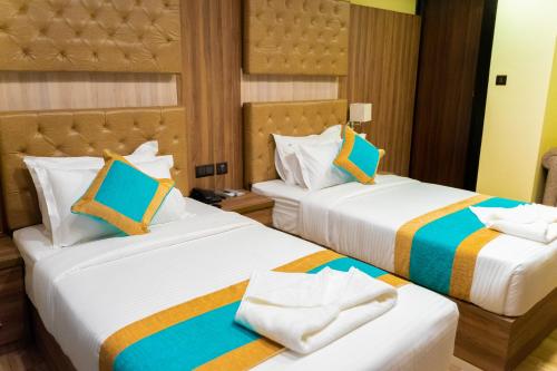 two beds in a hotel room with two beds at Grand Yak Boutique Hotel in Kathmandu