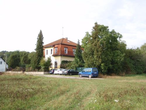 a blue van parked in front of a house at Pension Stará Škola in Hrubá Skála