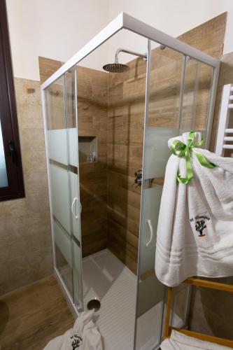 a shower with a glass door with a bow on it at A Ficurigna in Marsala