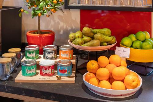 a display of oranges and other fruits on a counter at Novotel Paris Vaugirard Montparnasse in Paris