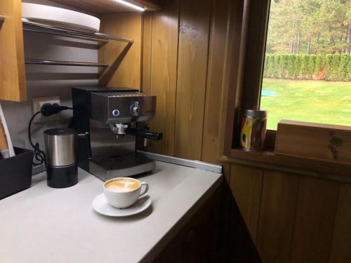 a cup of coffee sitting on top of a counter at MAGNET - private chalet in Razlog