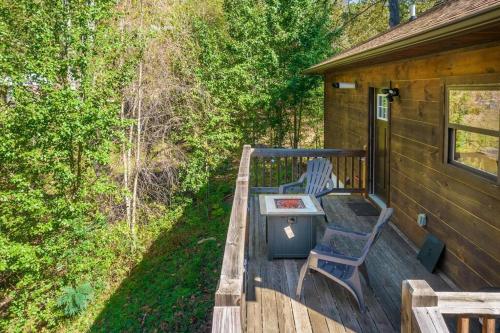 a deck with a table and two chairs on it at *NEW* Cozy mountain view cabin close to lake and hiking in Robbinsville