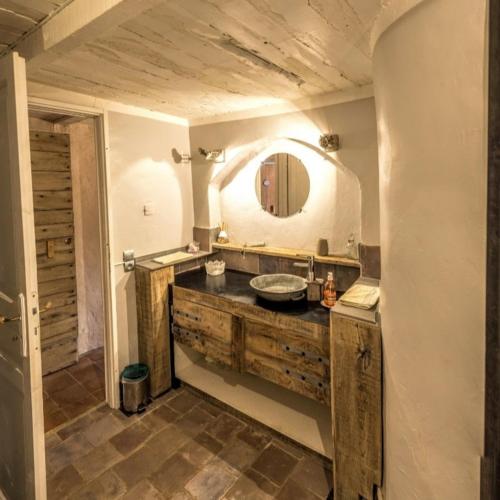 une salle de bain avec un lavabo et un miroir dans l'établissement La Medievale du Luberon, à Roussillon