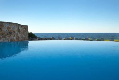 a large swimming pool with the ocean in the background at Cliff House Maine in Cape Neddick