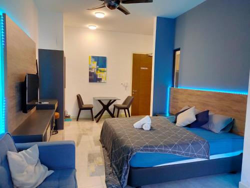 a bedroom with a bed and a table with chairs at Imperio Residence Bathtub Studio at Malacca Town-Near JONKER STREET in Melaka
