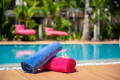 a pair of rolled up towels next to a swimming pool at Toparadis Guest House in Pereybere