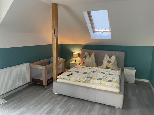 a bedroom with a bed and a sink and a window at Apartamenty u Tatiany in Międzywodzie