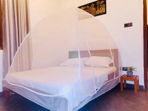 מיטה או מיטות בחדר ב-Nilupul Villa