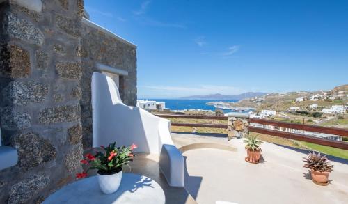 a balcony with stairs and a view of the ocean at Crystal Suites in Mýkonos City