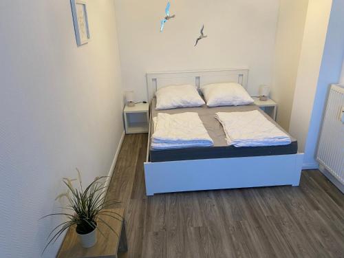 a bedroom with a bed and two night stands at Ferienwohnung Elena in Scharbeutz