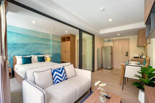 a bedroom with a bed and a living room at Lacasita Near Beach Huahin (Room21) in Hua Hin