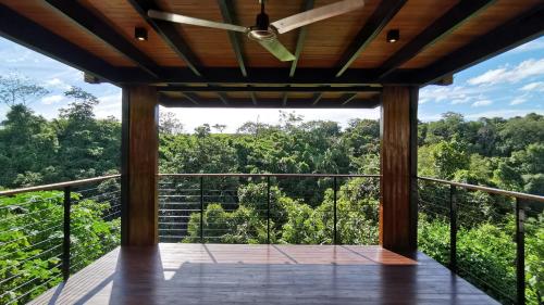 a balcony with a view of the forest at HBG Glamping community Yoga & Wellness space in Santa Teresa Beach