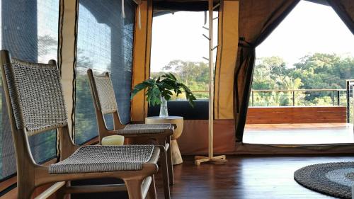two chairs sitting in a room with a large window at HBG Glamping community Yoga & Wellness space in Santa Teresa Beach