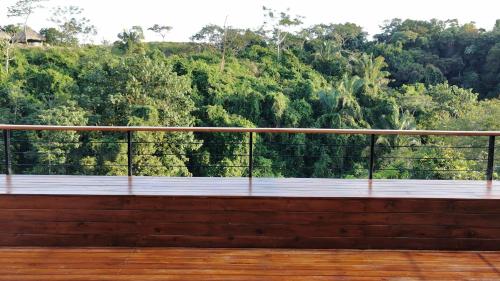 a balcony with a view of a forest at HBG Glamping community Yoga & Wellness space in Santa Teresa Beach