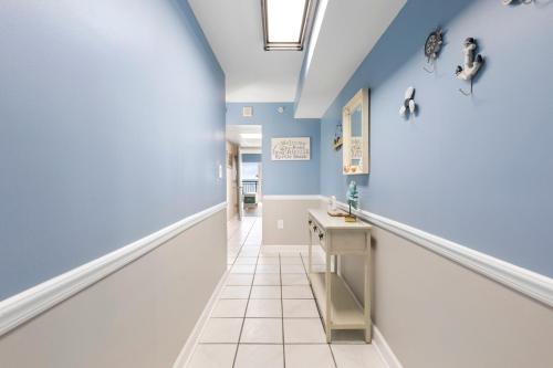 a hallway with blue walls and a tile floor at 11-th Floor OcenView w Balcony cozy condo at Boardwalk Resort in Myrtle Beach