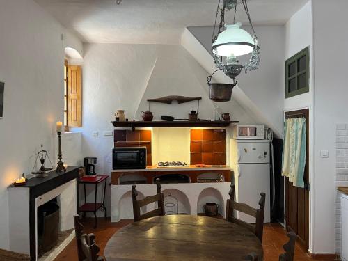 a kitchen with a wooden table in a room at Casa Musicale in Pigna