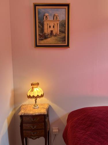 a lamp on a night stand next to a bed at Casa Musicale in Pigna