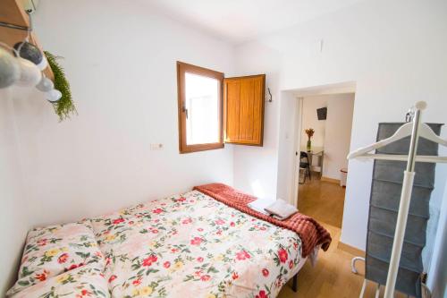 a bedroom with a bed and a mirror in it at Carmen Aljibe de la Miel in Granada