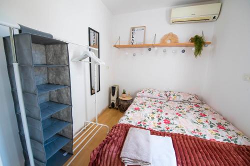 a bedroom with a bed and a shelf at Carmen Aljibe de la Miel in Granada