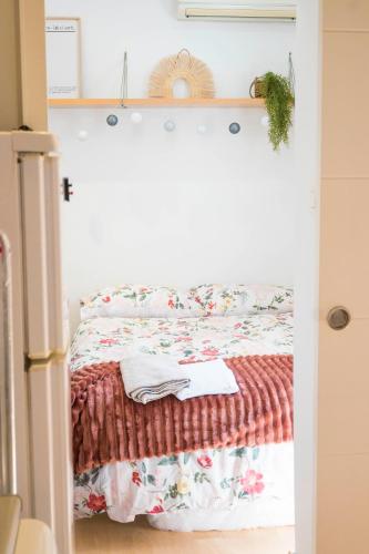 a bedroom with a bed with a blanket at Carmen Aljibe de la Miel in Granada