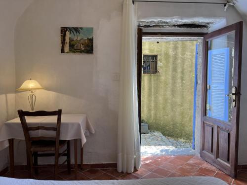 a table and a chair in a room with a window at Casa Musicale in Pigna