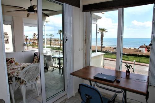 a dining room with a table and a view of the ocean at Уютная квартира на берегу моря с частным бесплантным пляжем in Antalya