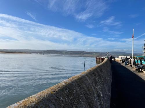 a retaining wall next to a body of water at Ground Floor Apartment in Exmouth