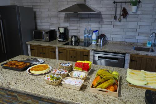 a kitchen counter with various food items on it at Casa Rural La Molinera Riolobos Caceres in Ríolobos
