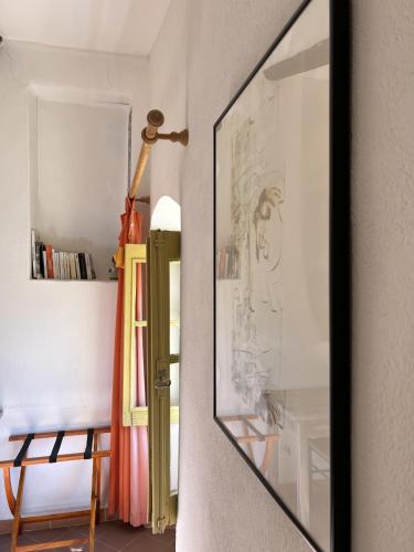a mirror hanging on a wall in a room at Casa Musicale in Pigna
