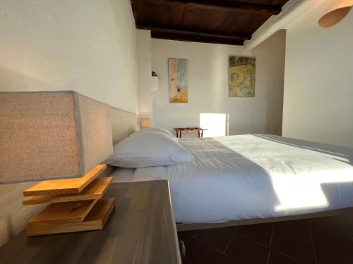 a bedroom with a large bed and a table at Casa Musicale in Pigna