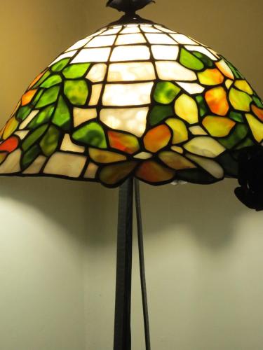 a stained glass lamp that is attached to a wall at 1900 B&B Terrassa in Terrassa