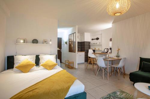 une chambre avec un lit et un salon dans l'établissement Studio Le Voltaire Sublime & Cosy proche Gare de Sète, à Sète