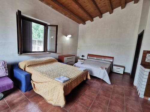 a bedroom with two beds and a window at Villa Patrizia in Canicattì