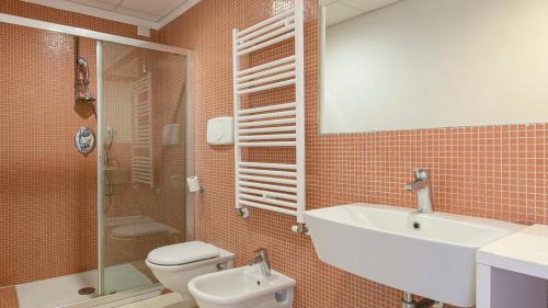 a bathroom with a toilet and a sink and a shower at Residenza Excelsior in Vasto