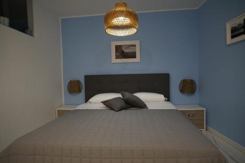 a bedroom with a large bed and a chandelier at Giata home in Naples